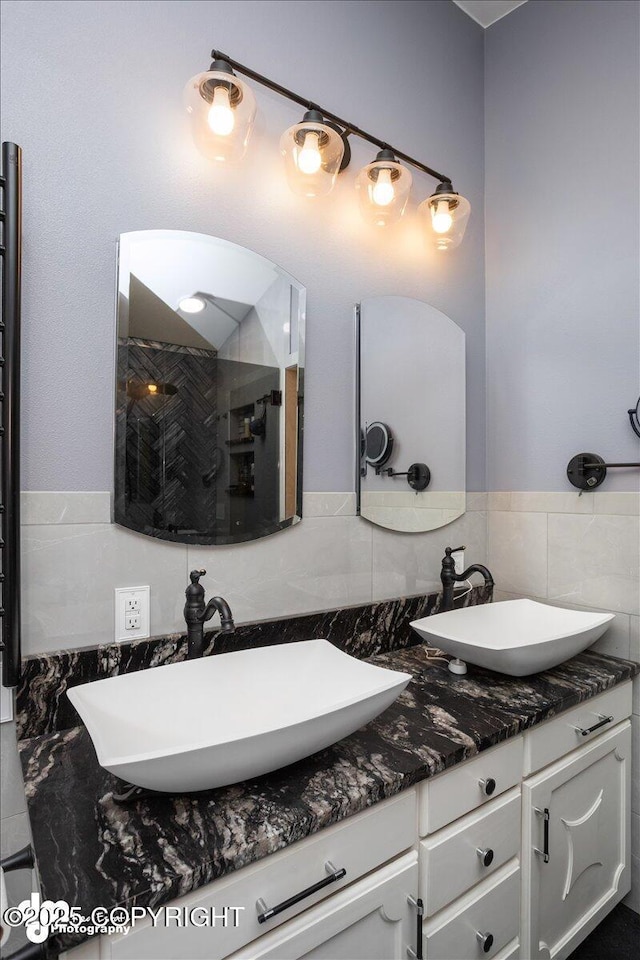 bathroom with vanity and a shower