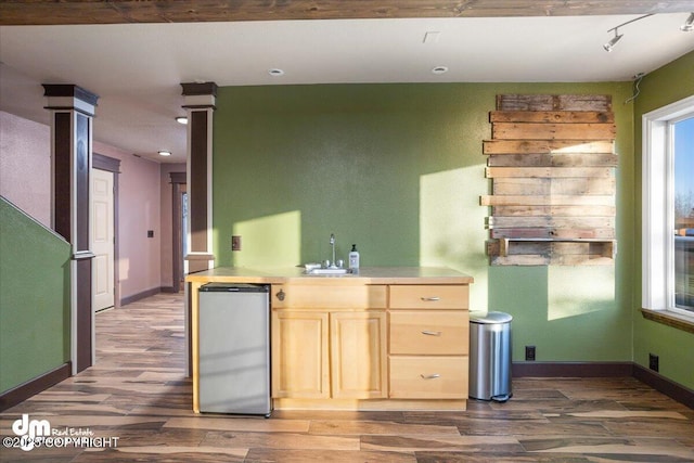 kitchen with stainless steel refrigerator, sink, dark wood-type flooring, and light brown cabinets