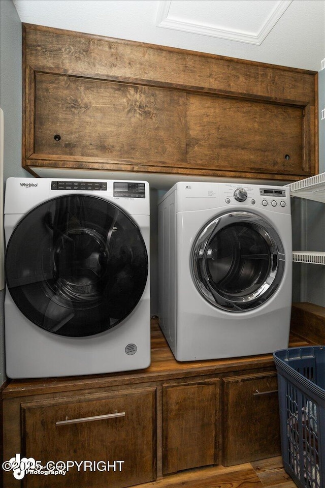 laundry area with cabinets and washing machine and clothes dryer