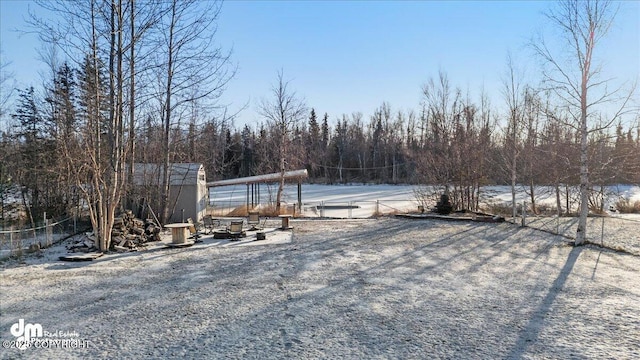 snowy yard with a shed