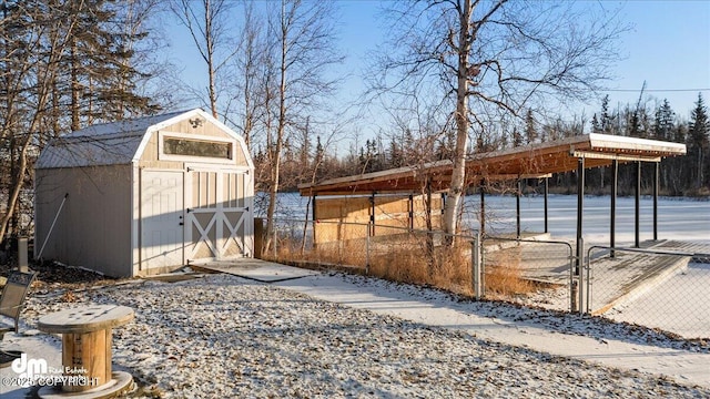 yard covered in snow with a storage shed