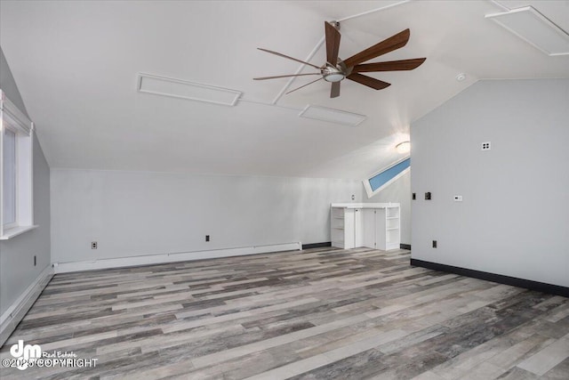 bonus room with vaulted ceiling, ceiling fan, light hardwood / wood-style floors, and a baseboard radiator