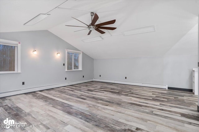 additional living space featuring ceiling fan, lofted ceiling, and light wood-type flooring