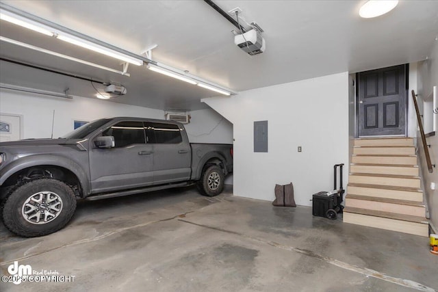 garage featuring a garage door opener and electric panel