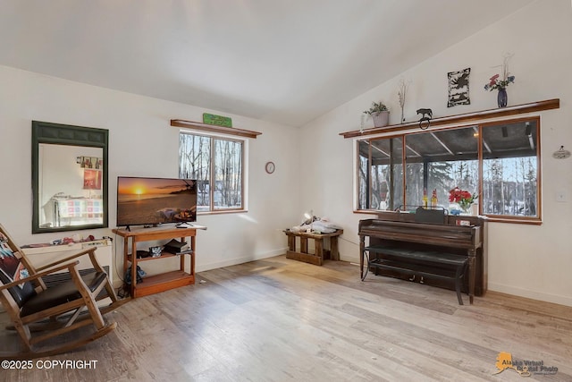 sitting room with lofted ceiling and light hardwood / wood-style floors