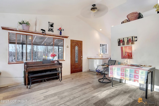 sitting room featuring high vaulted ceiling and light wood-type flooring