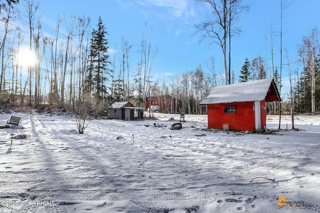 snowy yard with a storage unit