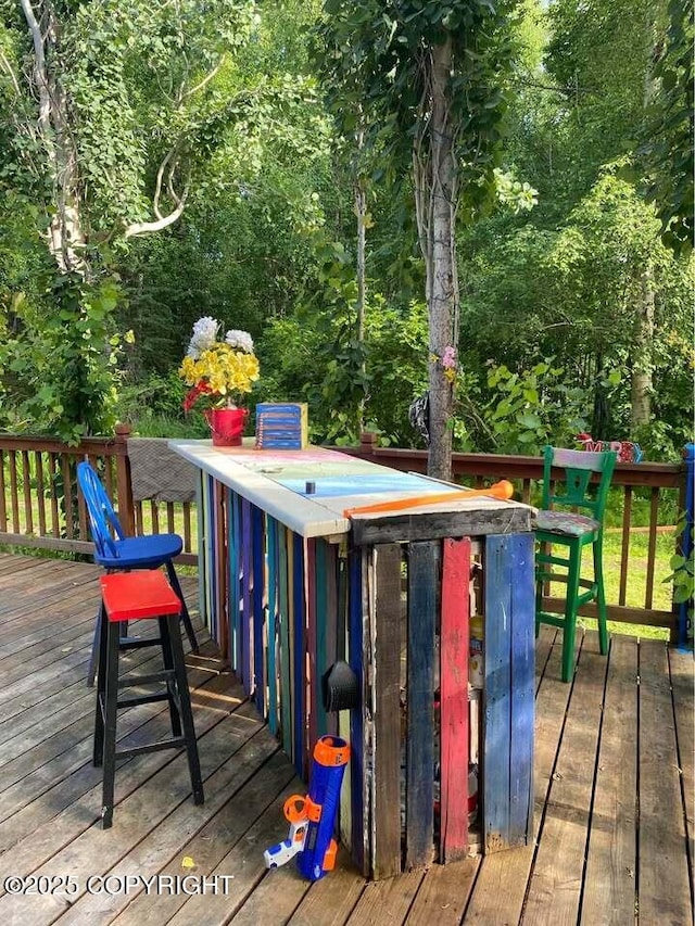 wooden deck featuring an outdoor bar