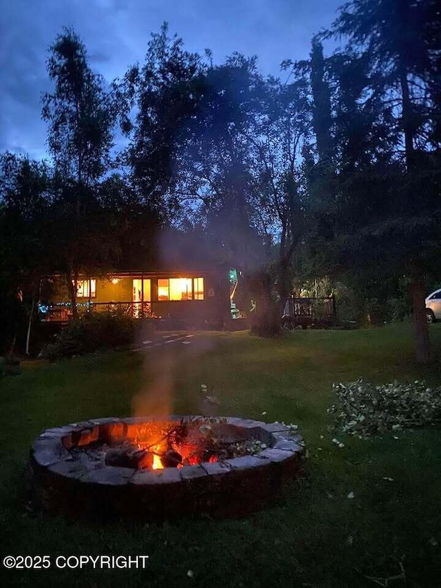 yard at dusk with a fire pit