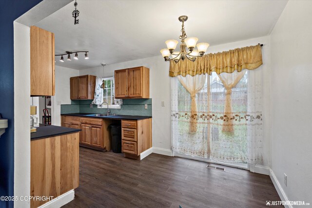 1510 E 40th Ct, Anchorage, AK 99508 - kitchen with dark countertops, a chandelier, and dark wood-style floors