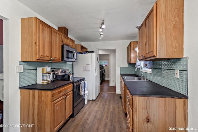 1510 E 40th Ct, Anchorage, AK 99508 - kitchen with appliances with stainless steel finishes, dark countertops, tasteful backsplash, wood finished floors, and brown cabinetry