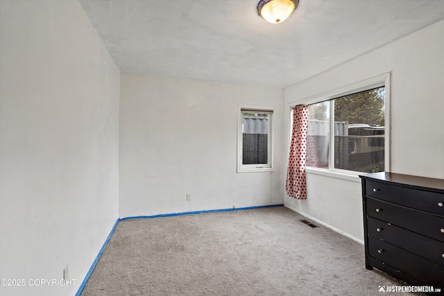 1510 E 40th Ct, Anchorage, AK 99508 - spare room featuring carpet floors and baseboards