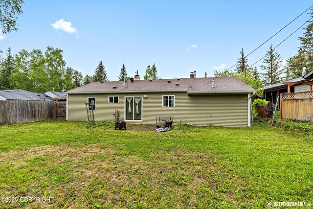 1510 E 40th Ct, Anchorage, AK 99508 - rear view of house featuring a fenced backyard and a chimney