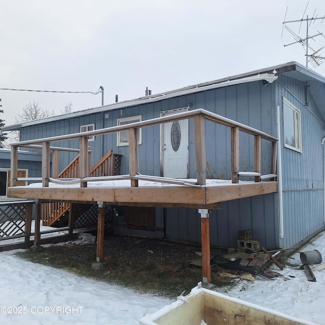 snow covered property featuring a wooden deck