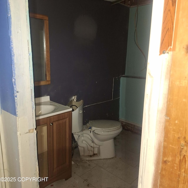 bathroom featuring tile patterned flooring, vanity, and toilet