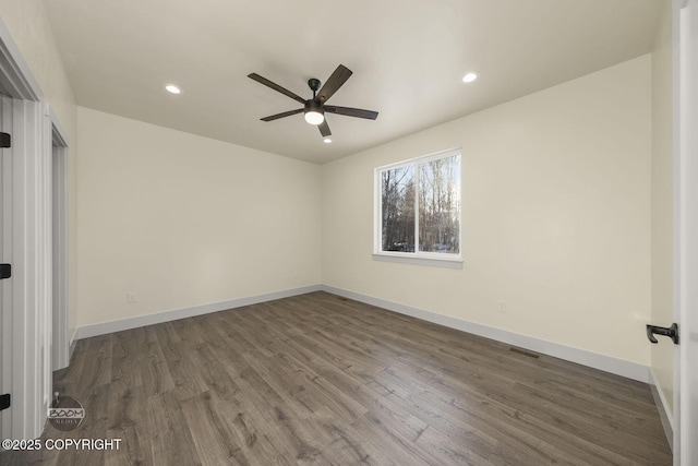 spare room featuring ceiling fan and dark hardwood / wood-style floors