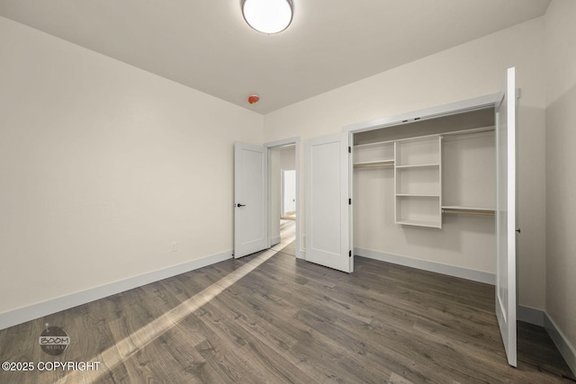 unfurnished bedroom featuring dark wood-type flooring and a closet