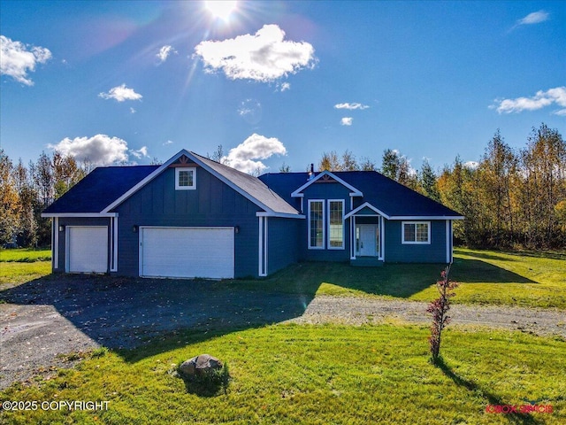 view of front of home with a garage and a front lawn