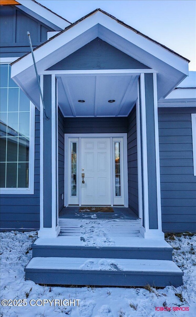 view of snow covered property entrance