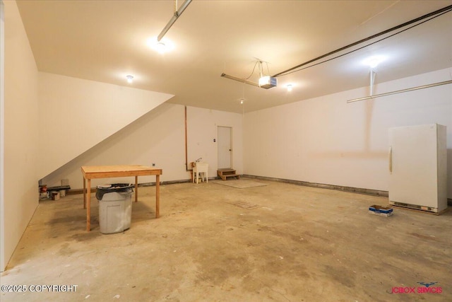 garage featuring a garage door opener and white fridge