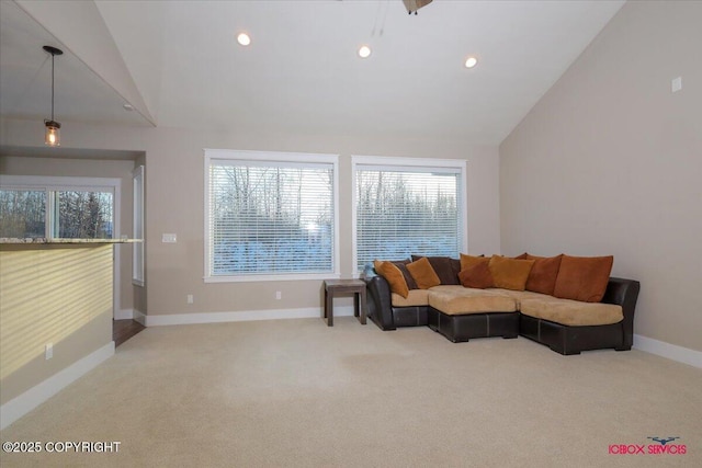 carpeted living room featuring high vaulted ceiling