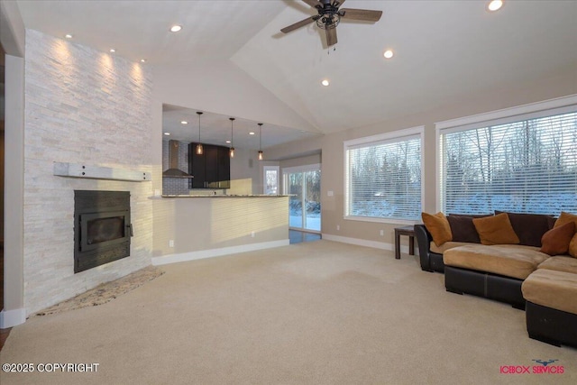 unfurnished living room with ceiling fan, high vaulted ceiling, light carpet, and a fireplace