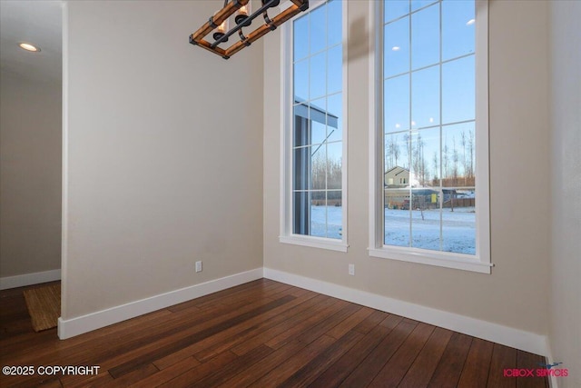 spare room featuring dark hardwood / wood-style flooring