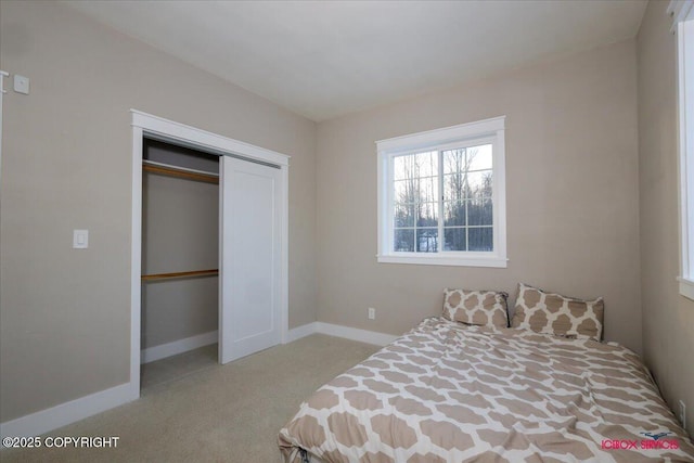 bedroom featuring light colored carpet and a closet