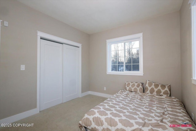 bedroom with a closet and light carpet