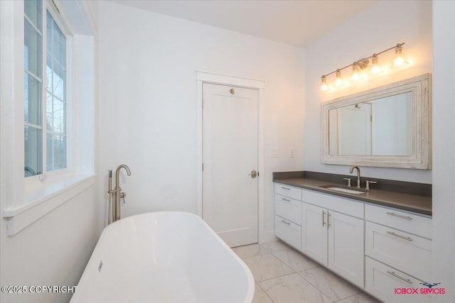 bathroom with vanity and a tub to relax in