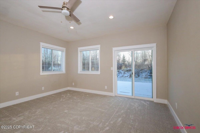 carpeted spare room with a wealth of natural light and ceiling fan