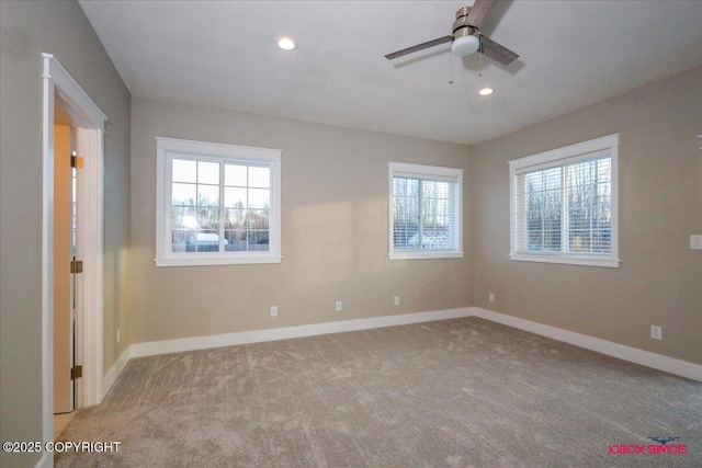 unfurnished room featuring ceiling fan, a healthy amount of sunlight, and light carpet