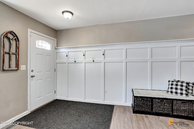 mudroom with light hardwood / wood-style floors