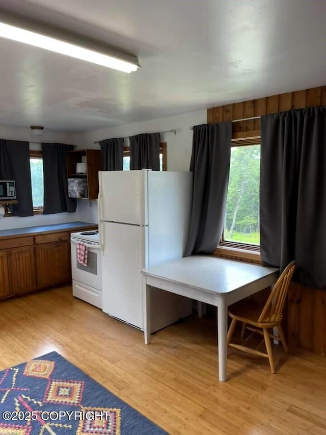 kitchen with white appliances and light wood-type flooring