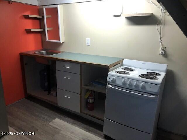 kitchen featuring gray cabinets, dark hardwood / wood-style floors, and white range with electric stovetop