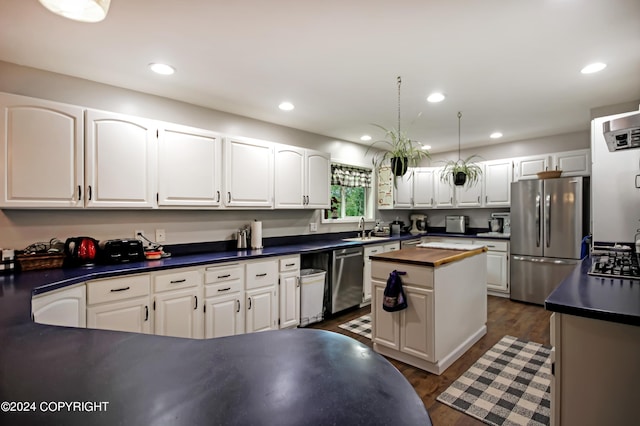 kitchen featuring sink, appliances with stainless steel finishes, white cabinets, and dark hardwood / wood-style flooring