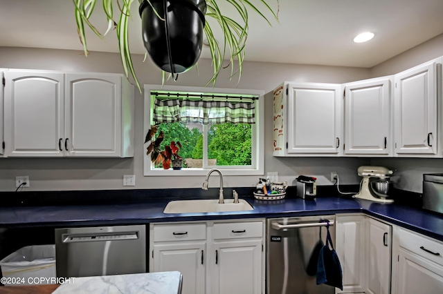 kitchen with white cabinets, dishwasher, and sink