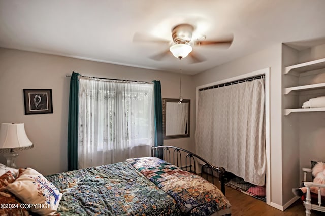 bedroom featuring a closet, hardwood / wood-style floors, and ceiling fan