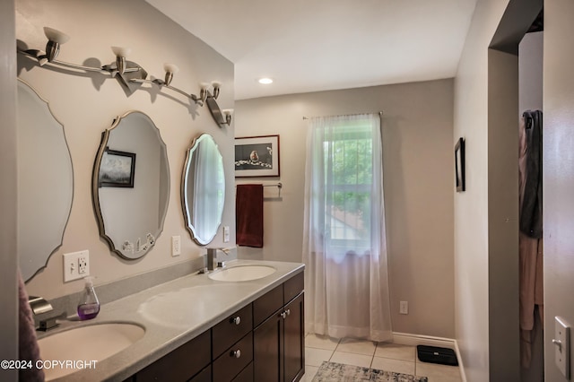 bathroom featuring tile patterned floors, ceiling fan, and vanity