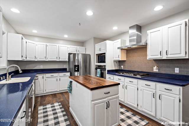 kitchen with white cabinetry, wall chimney range hood, and stainless steel appliances