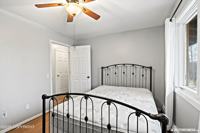 bedroom with hardwood / wood-style floors and ceiling fan