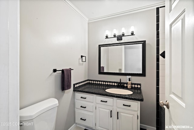 bathroom with ornamental molding, toilet, and vanity