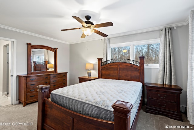 bedroom featuring light carpet, crown molding, and ceiling fan