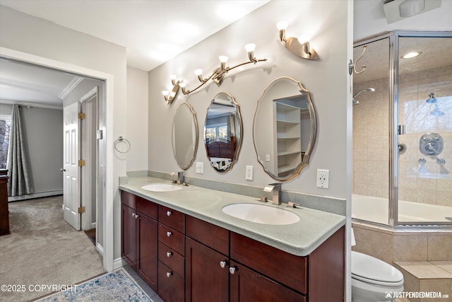 full bathroom with vanity, a baseboard heating unit, toilet, enclosed tub / shower combo, and ornamental molding