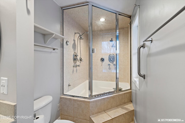 bathroom featuring shower / bath combination with glass door and toilet