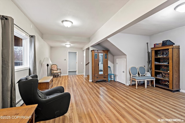 sitting room with a baseboard heating unit and light hardwood / wood-style floors