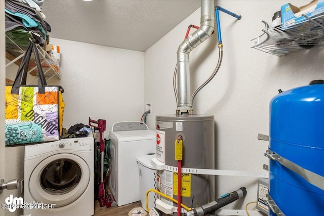 laundry room featuring water heater, hardwood / wood-style floors, a textured ceiling, and independent washer and dryer