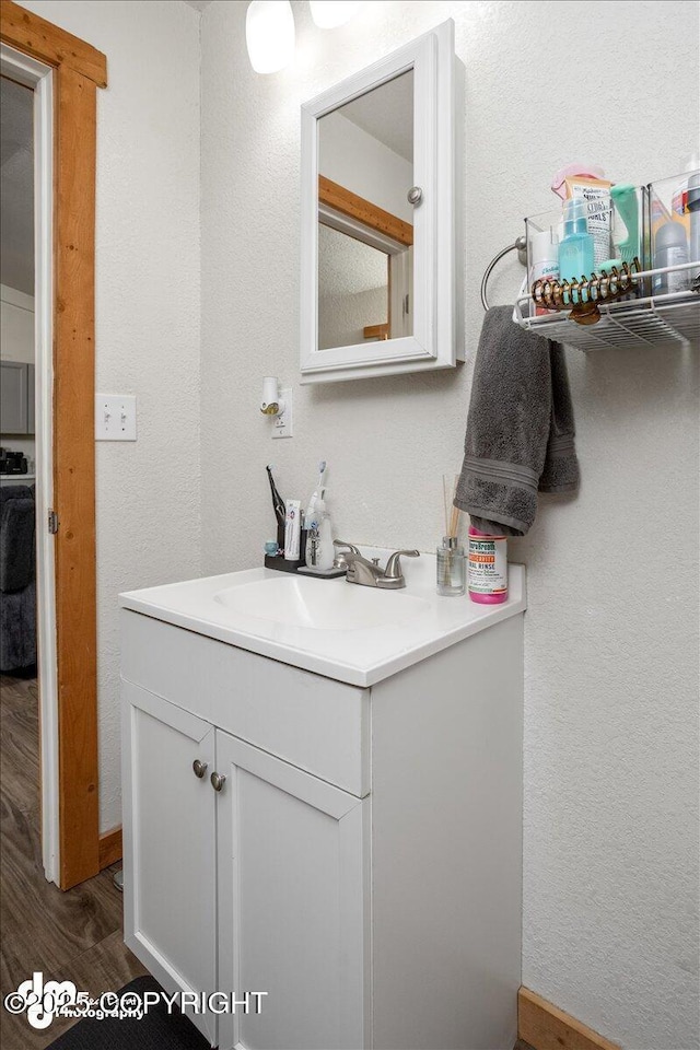 bathroom with hardwood / wood-style flooring and vanity