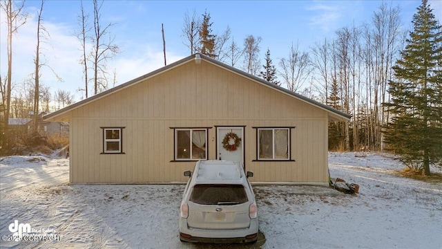 view of snow covered back of property