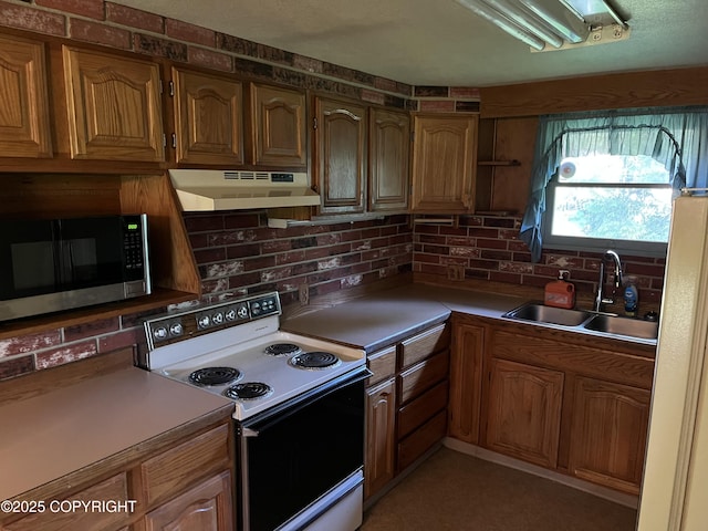 kitchen featuring tasteful backsplash, sink, and range with electric stovetop